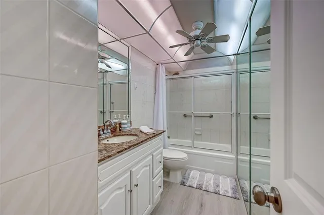 a view of a swimming pool with a table and chairs under an umbrella