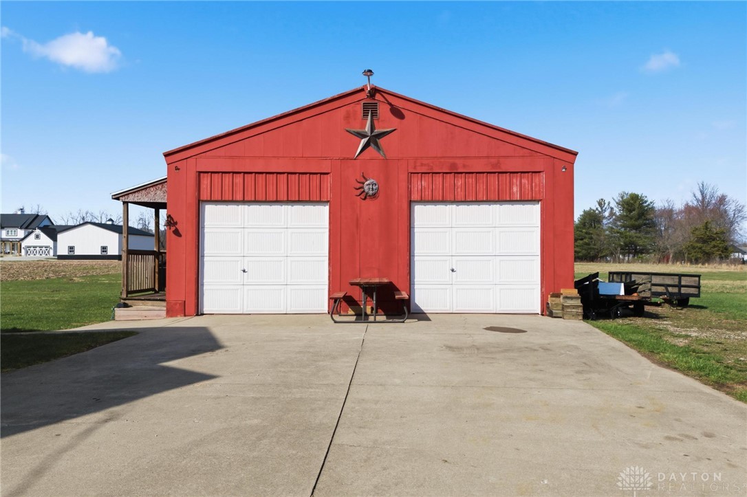 11379 Friend Road Germantown, OH 45327 - Photo 4 of 44 This vibrant red garage with dual bays offers ample space for vehicles and storage.