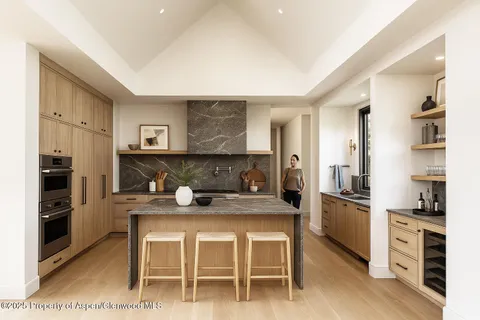 a kitchen with a table and chairs in it