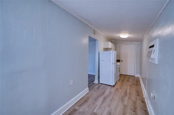 a view of a hallway with wooden floor