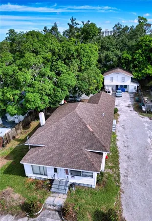 an aerial view of a house with a yard