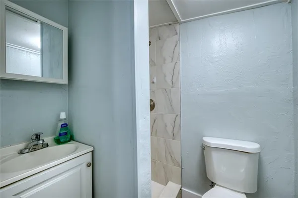 a bathroom with a toilet sink and shower