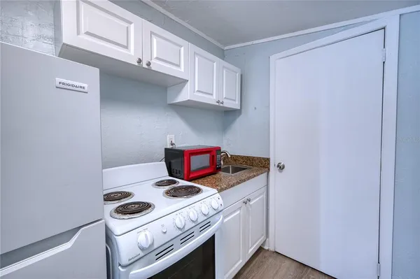 a kitchen with a stove and cabinets
