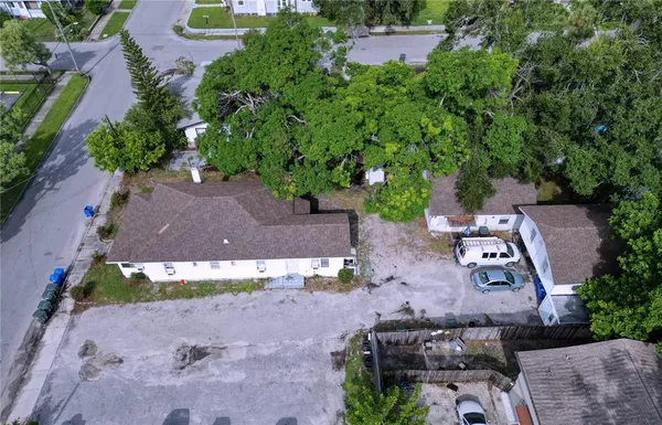 an aerial view of a house with a yard and garden