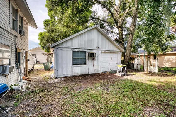 a view of a house with a yard and trees