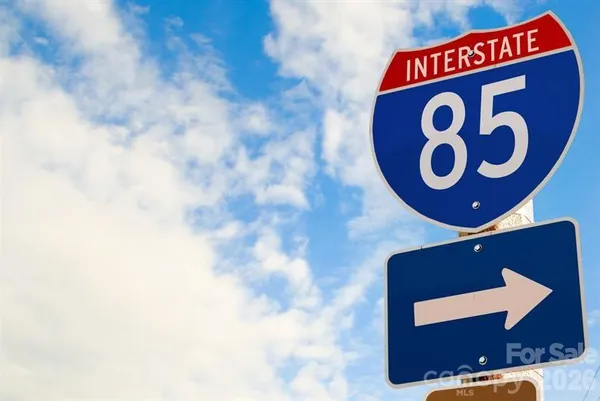 a view of a patio with table and chairs potted plants and a barbeque