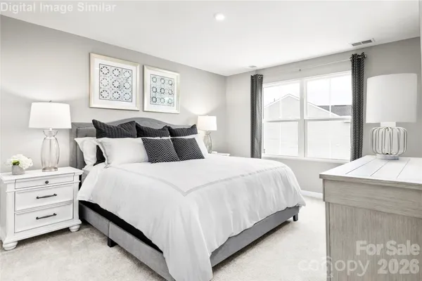 a bedroom with a bed and a night stand