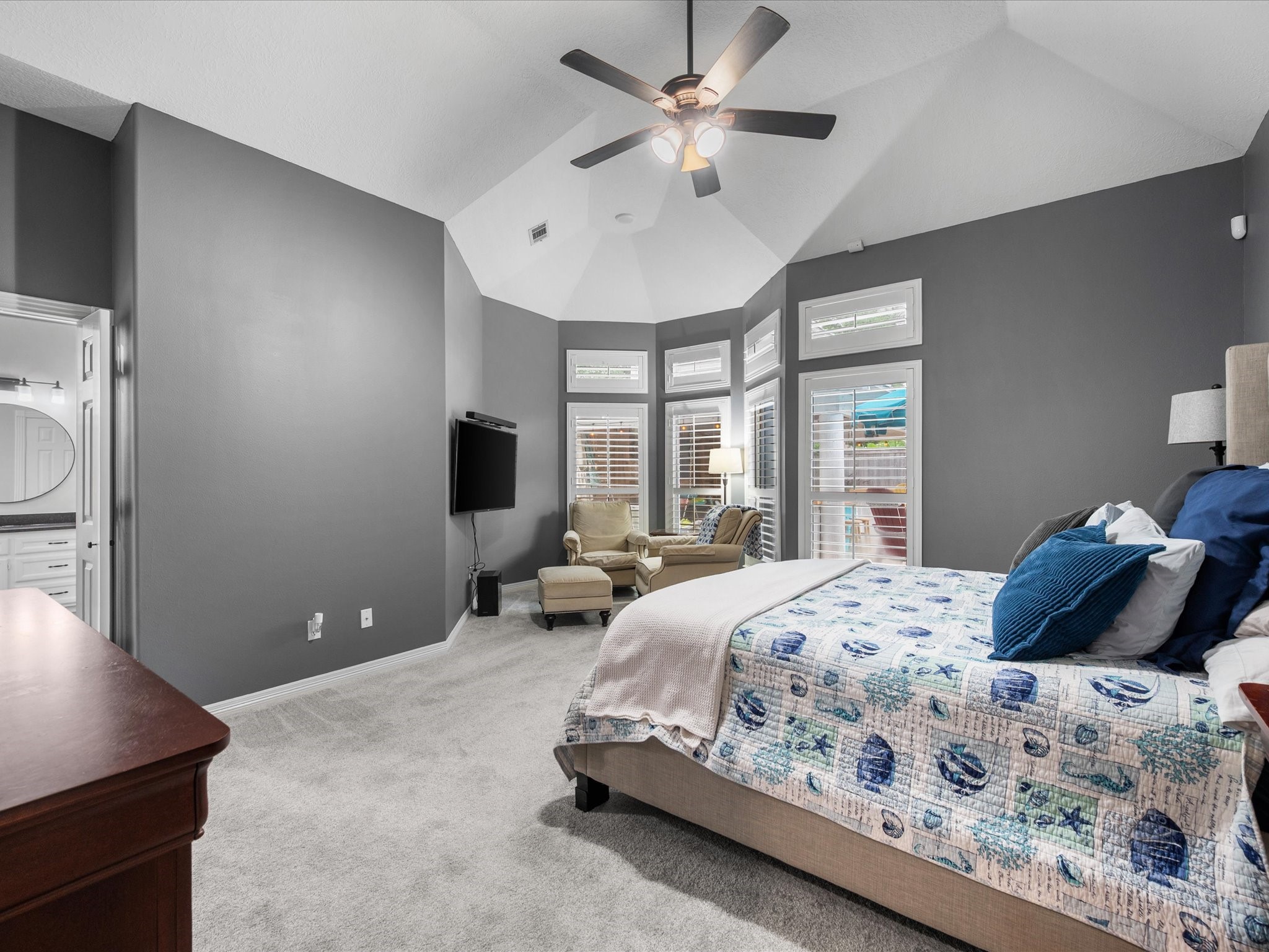 5910 Center Ct Drive Spring, TX 77379 - Photo 20 of 50 The expansive primary suite features soaring ceilings, a sitting area, and large windows that fill the space with natural light, while the updated ensuite enhances the sense of comfort and refinement.