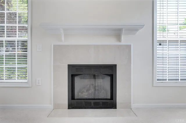 a view of a livingroom with a fireplace and window