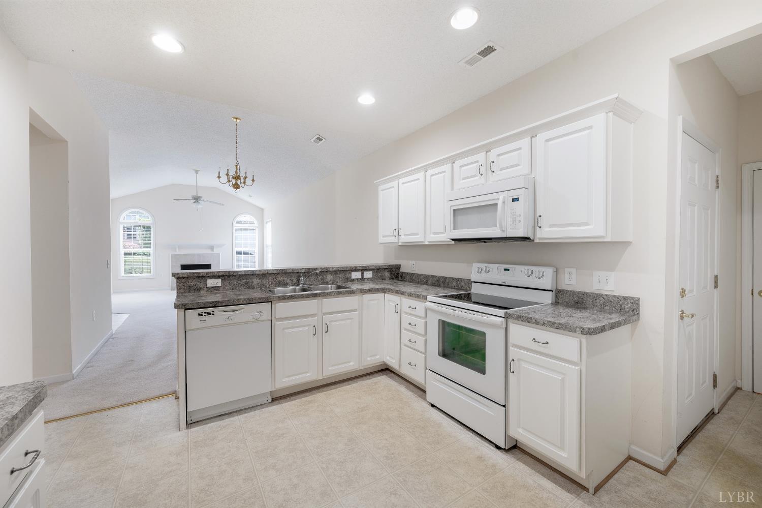 1159 Jefferson Way Forest, VA 24551 - Photo 30 of 43 a kitchen with stainless steel appliances granite countertop a stove and white cabinets
