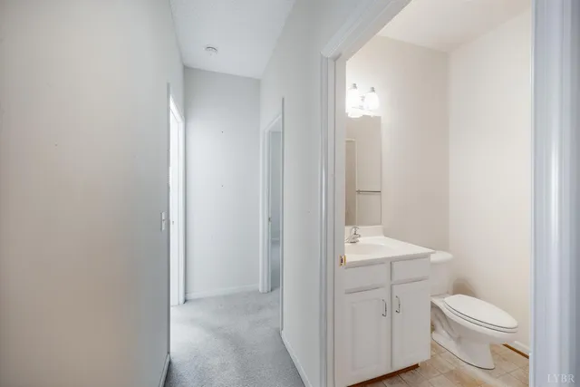 a bathroom with a toilet a sink and a mirror