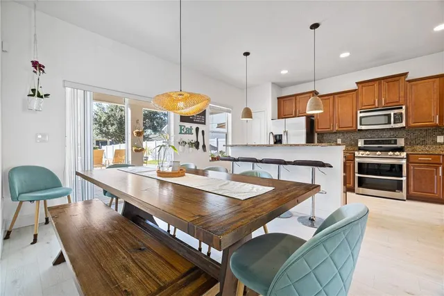 a kitchen with stainless steel appliances granite countertop a sink a stove and a refrigerator