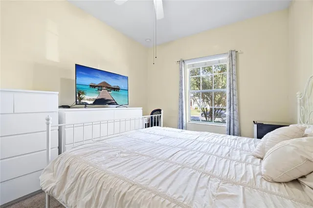 a bedroom with a bed and a chair