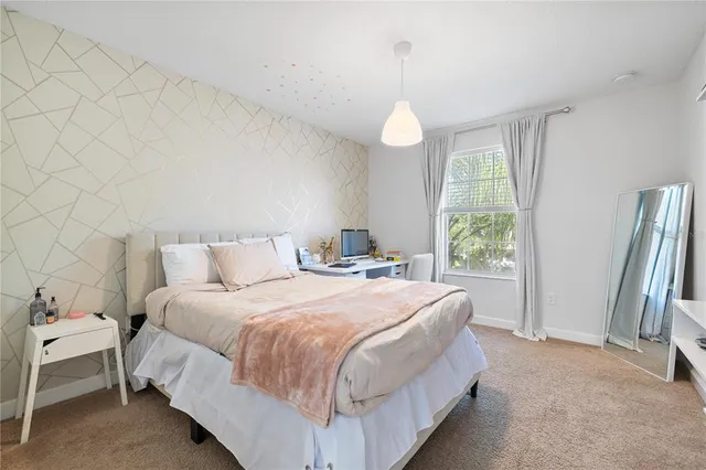 a bedroom with a bed and a chandelier