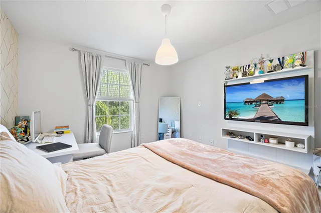 a bathroom with a granite countertop bathtub a sink and a large mirror