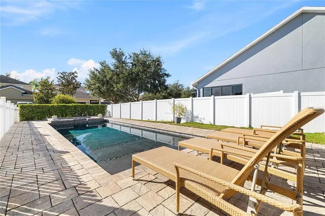 a view of a house with swimming pool and sitting area
