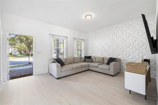 a living room with furniture and a potted plant