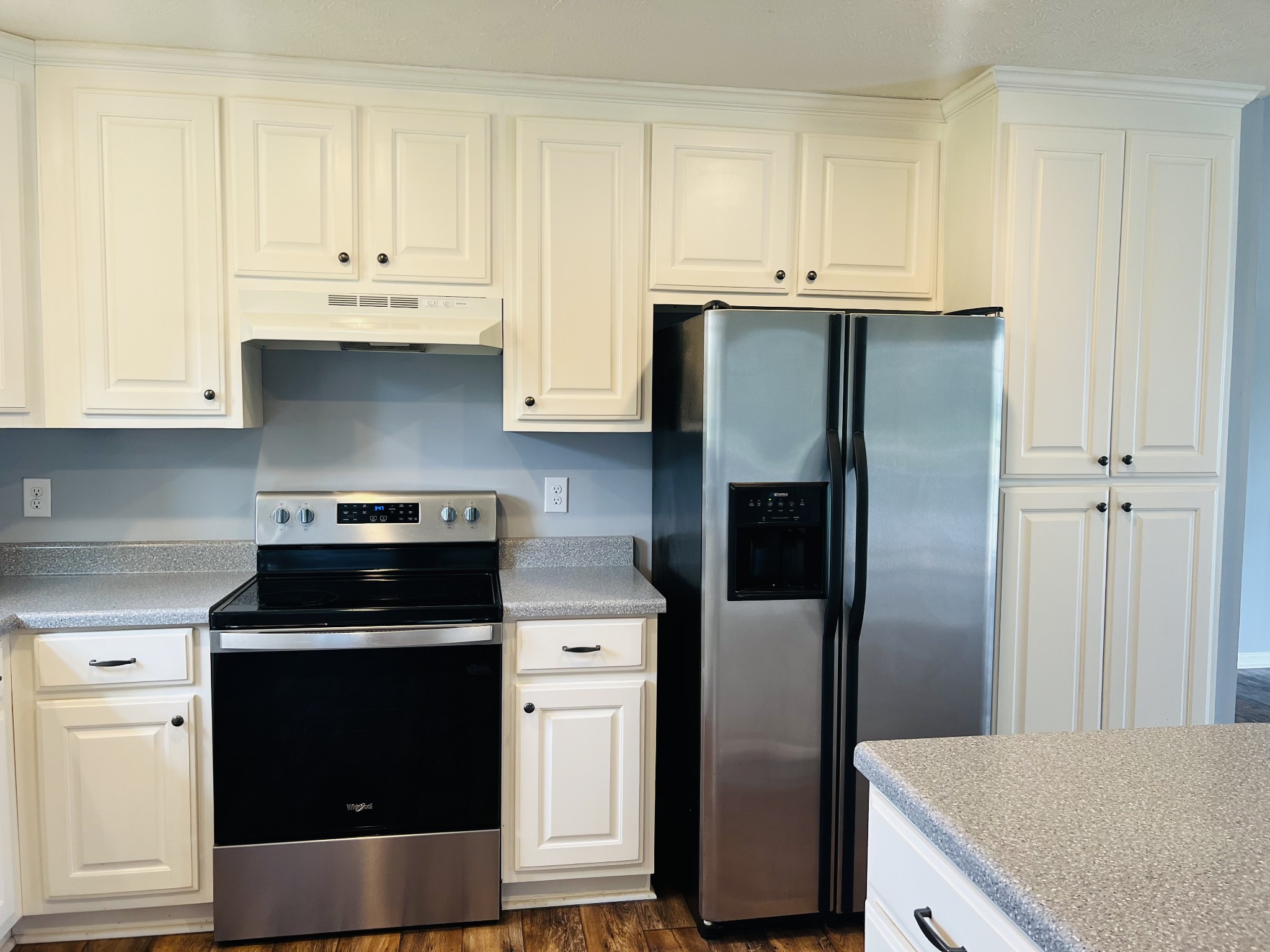 4560 Fall River Road Pulaski, TN 38478 - Photo 8 of 28 a kitchen with stainless steel appliances granite countertop a refrigerator stove and white cabinets