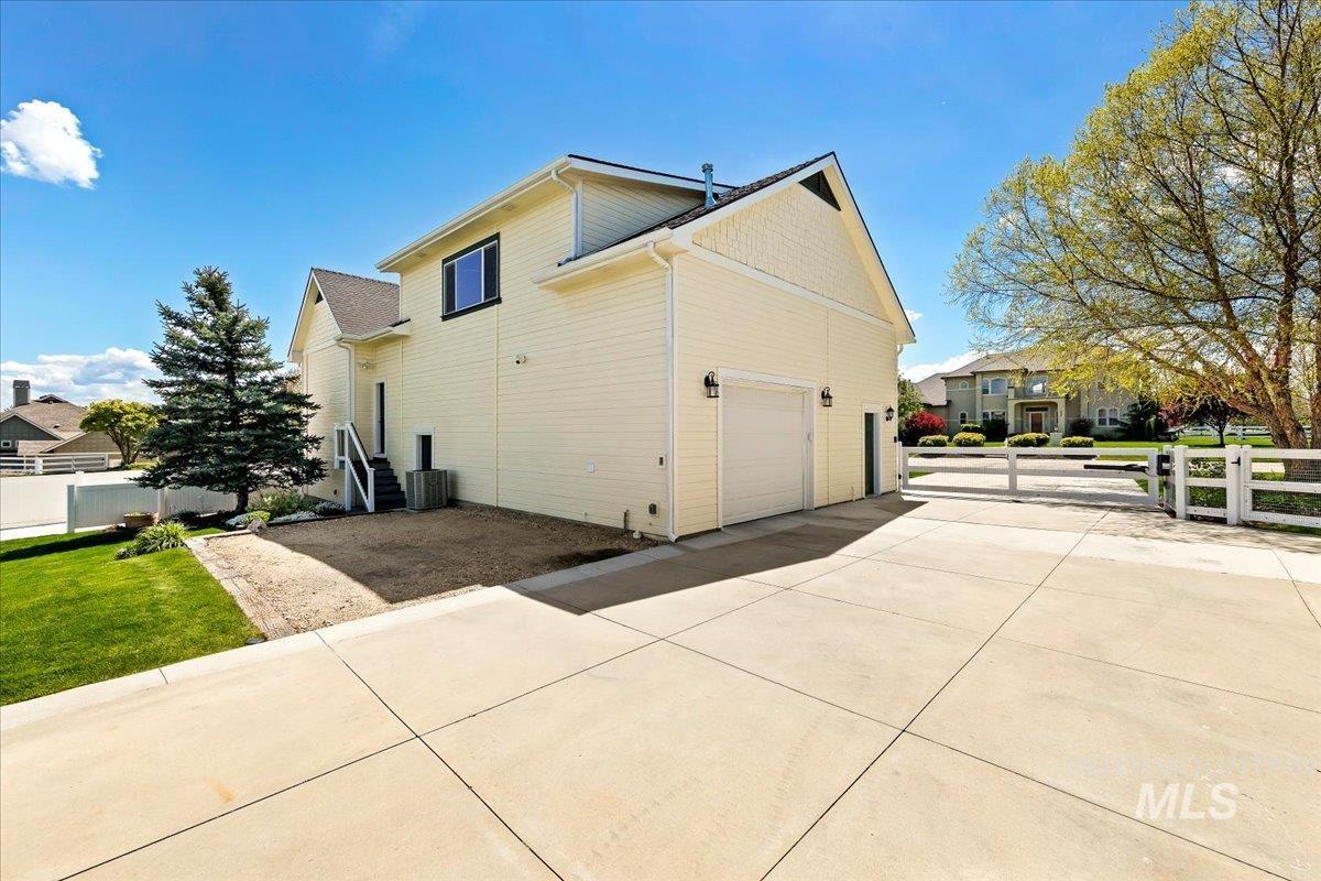 414 East Shafer View Drive Meridian, ID 83642 - Photo 38 of 50 Expansive concrete driveway leading to the 56x40 Shop built in 2023-1047 sq. ft. living space above. Lower level has a workshop, 28x11 Boat Bay & a 40x16 RV Bay with 14' tall x 12' wide RV garage door! Additional exterior RV parking space & garden shed