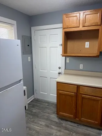 a utility room with a sink a microwave and cabinets