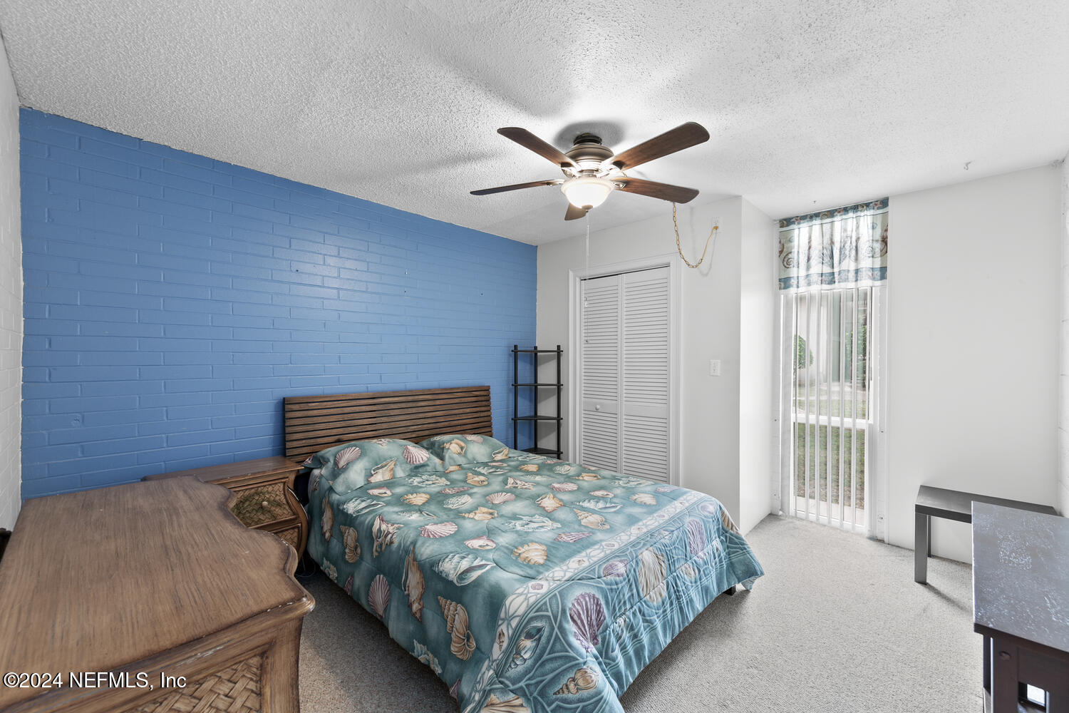 901 Ocean Boulevard, Unit 45 Atlantic Beach, FL 32233 - Photo 17 of 26 a bedroom with a large bed and a chandelier