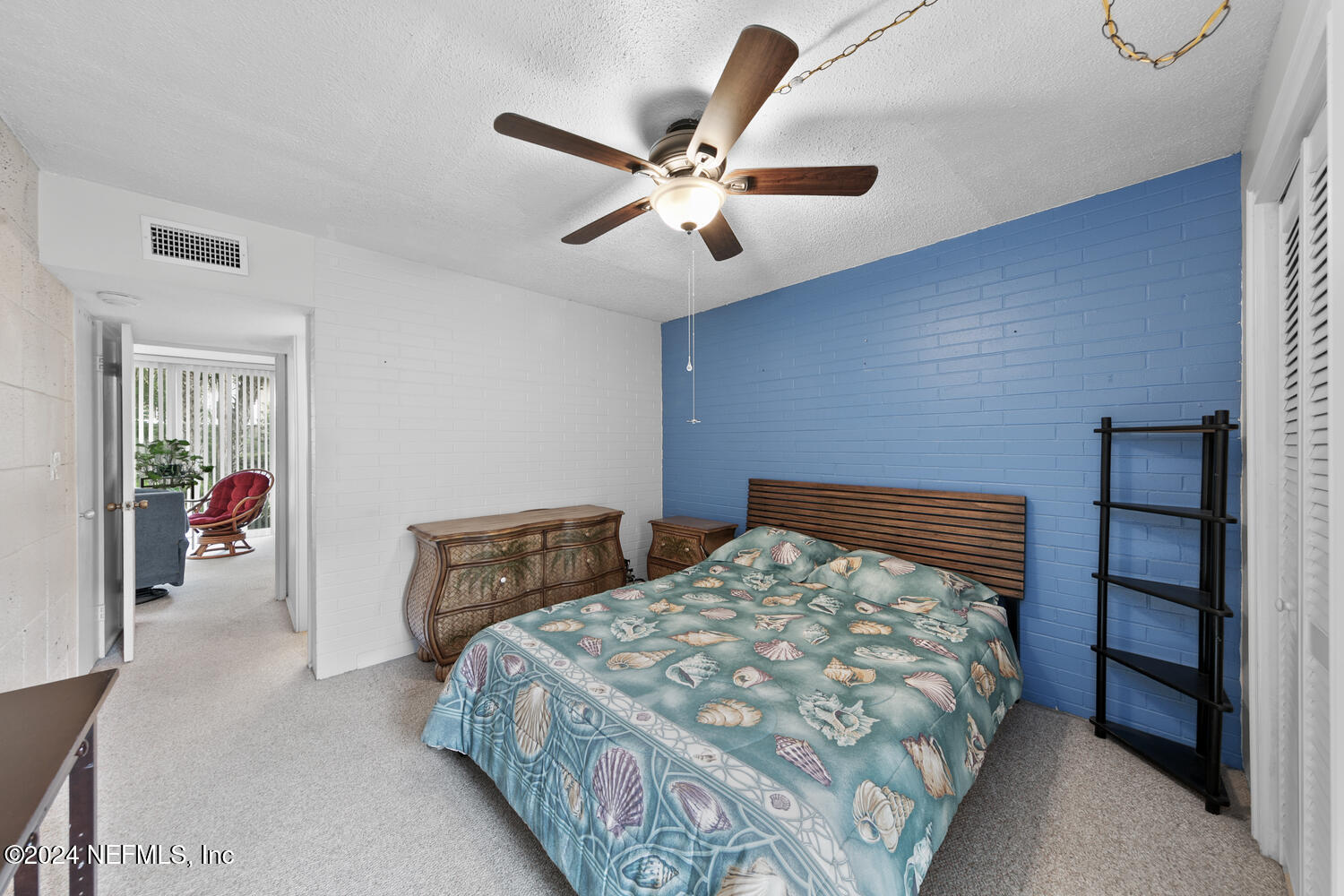 901 Ocean Boulevard, Unit 45 Atlantic Beach, FL 32233 - Photo 18 of 26 a bedroom with a bed and a chandelier