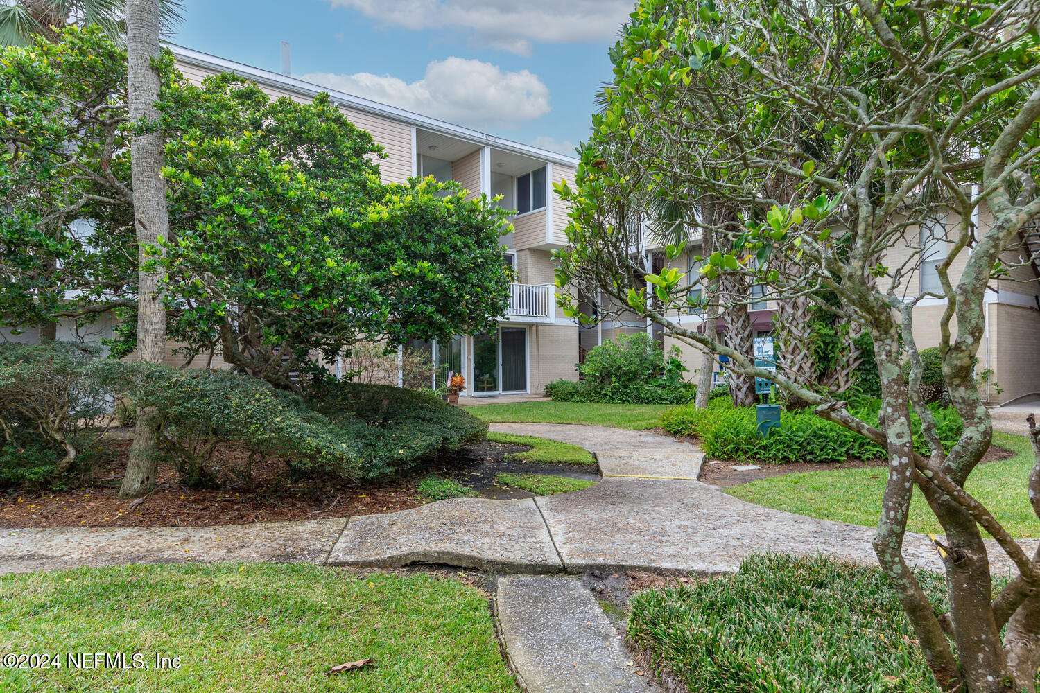 901 Ocean Boulevard, Unit 45 Atlantic Beach, FL 32233 - Photo 23 of 26 a front view of a house with a yard and a garden