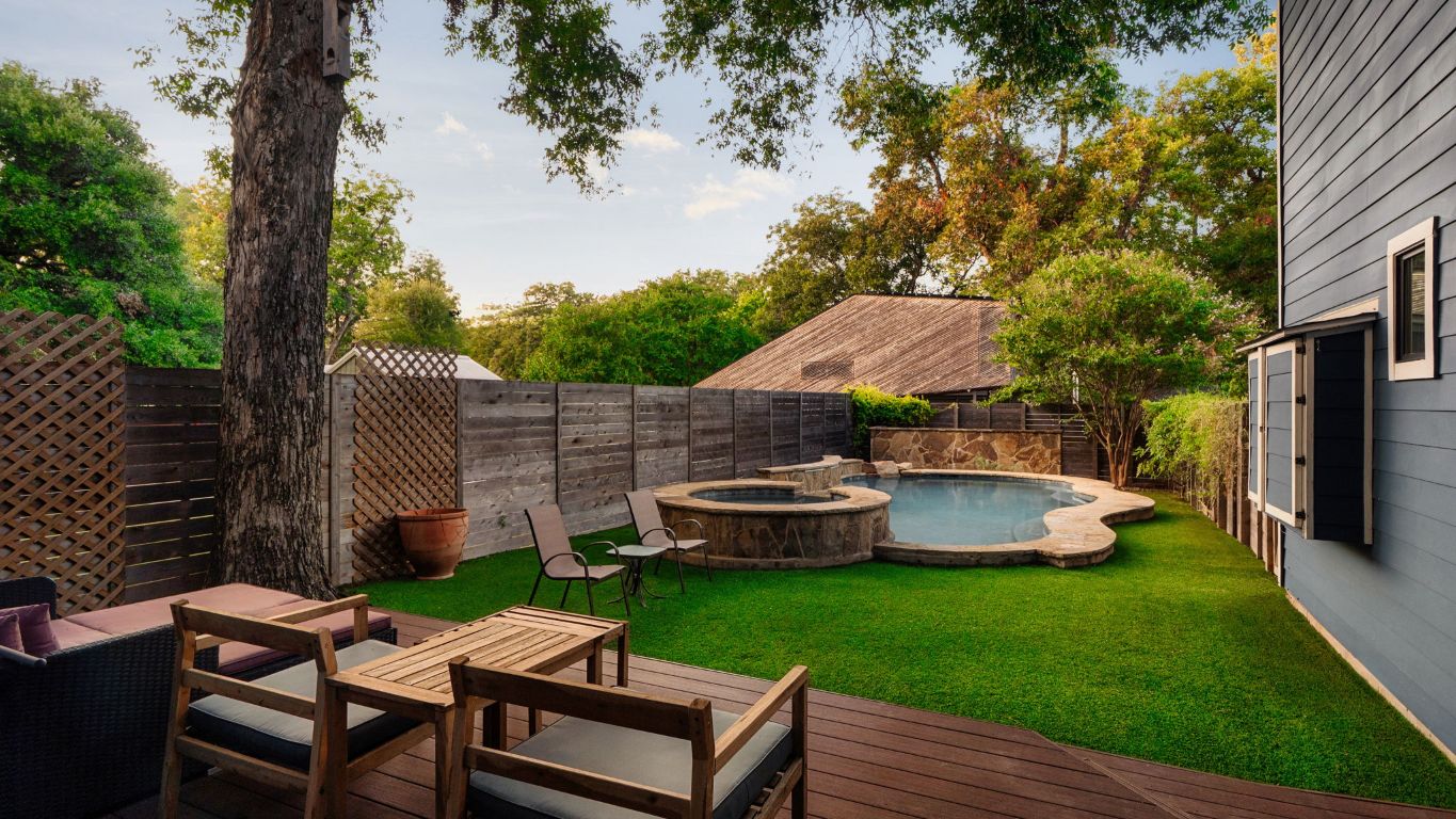 a backyard of a house with table and chairs