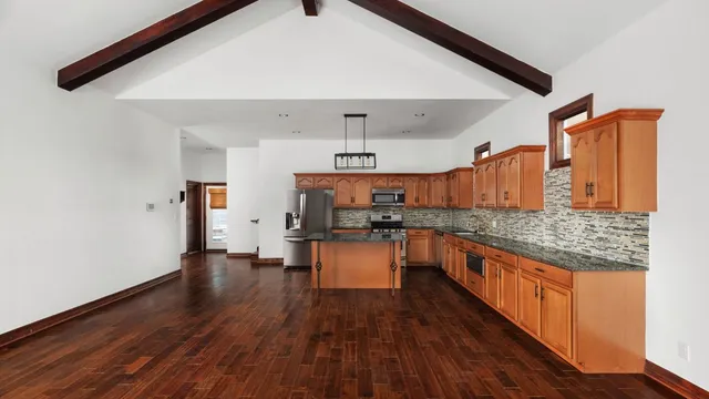 a kitchen with a sink a counter top space and stainless steel appliances