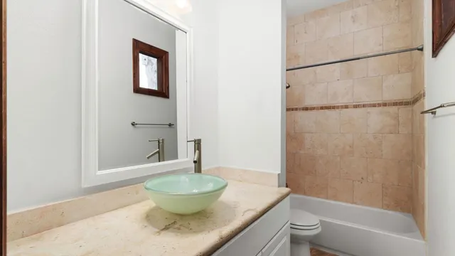 a bath room with a toilet and a bath tub