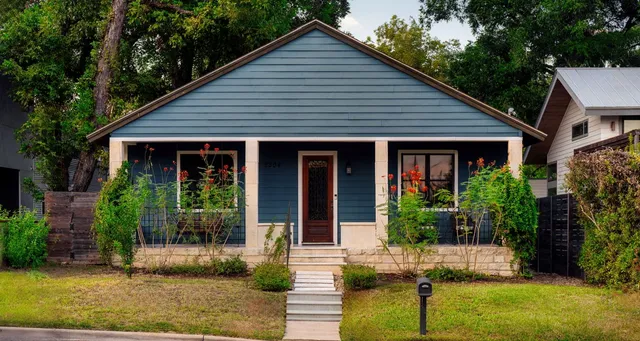 a front view of house with a garden