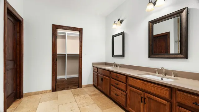 a bathroom with a double vanity sink and mirror