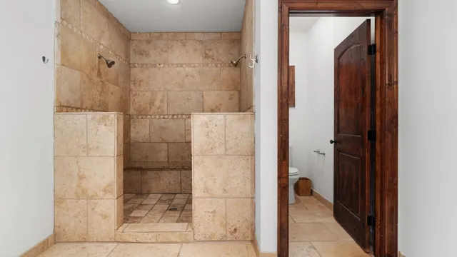a bathroom with a shower and a glass door