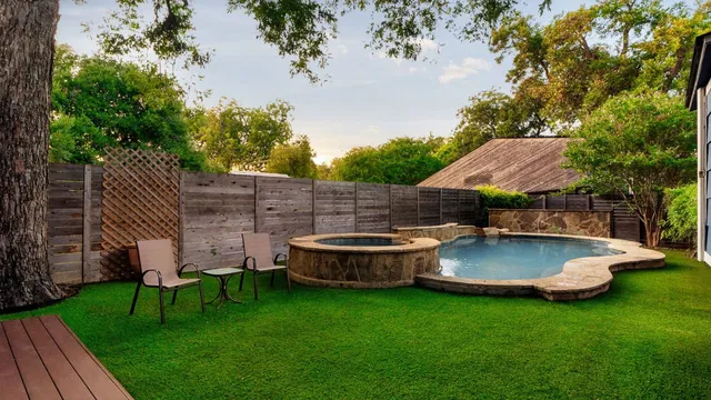 a view of house with backyard and outdoor seating