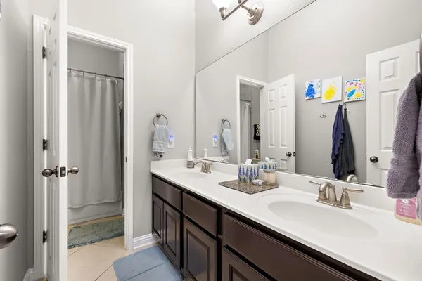 a bathroom with a double vanity sink and a mirror