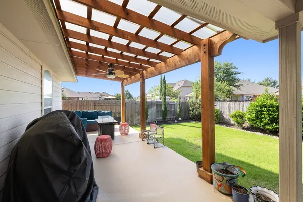 a view of a porch with furniture and garden