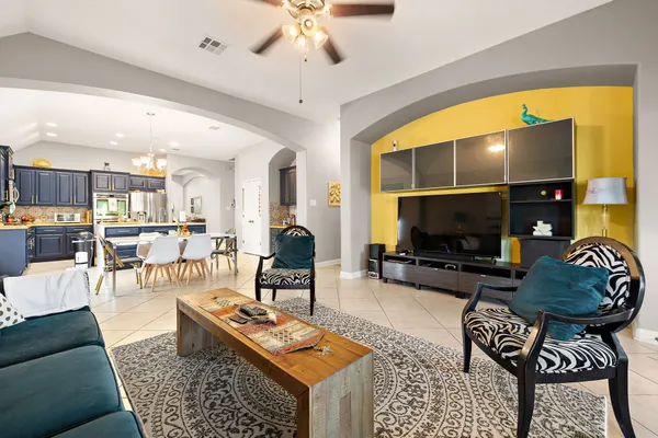 a living room with furniture a rug and a flat screen tv