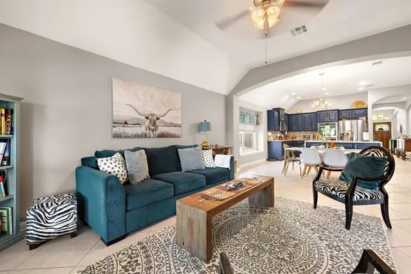 a living room with furniture and a chandelier