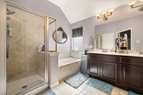 a bath room with a sink a mirror and a shower