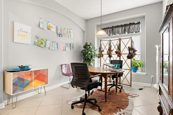 a work room with furniture and a large window