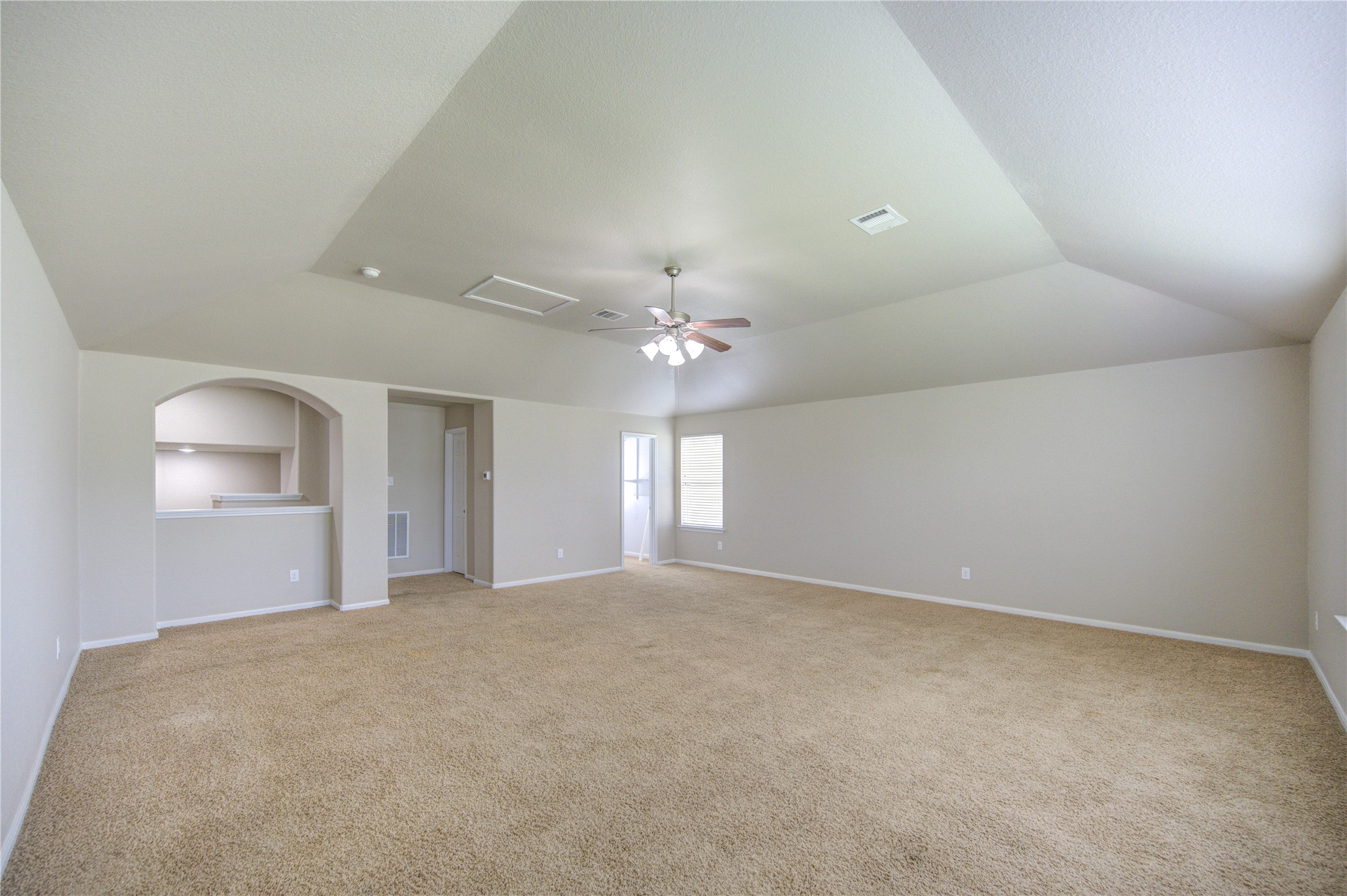 6014 Watford Bend Rosenberg, TX 77471 - Photo 17 of 18 20 – Expansive upstairs flex room with vaulted ceilings—endless possibilities for media, lounge, gym, gaming, or creative use.