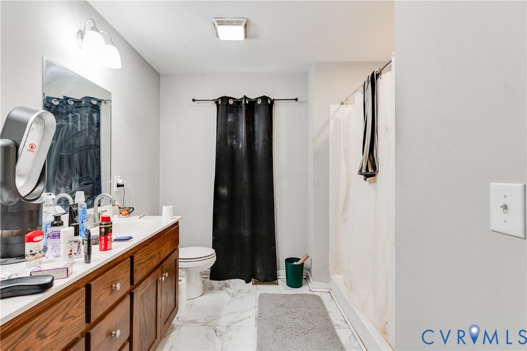 24580 St James Road Jetersville, VA 23083 - Photo 16 of 25 Bathroom featuring a wood-finish vanity with an in