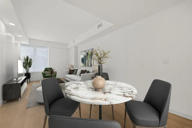 a dining room with furniture and wooden floor