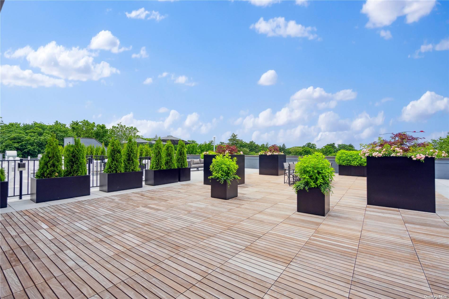 218 Middle Neck Road, Unit 314 Great Neck, NY 11021 - Photo 9 of 23 a house with a yard and potted plants