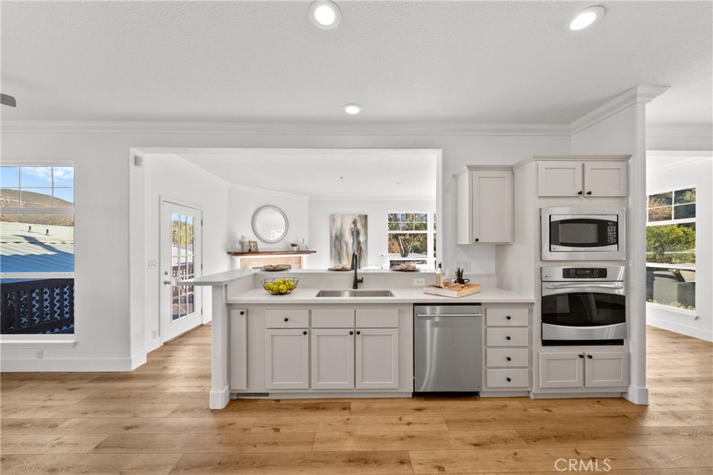 a kitchen with stainless steel appliances kitchen island granite countertop a sink and cabinets