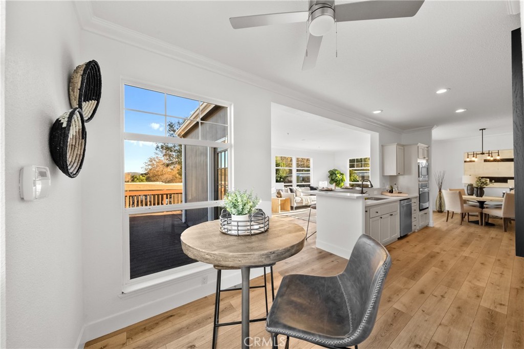 3909 Reche Road, Unit 60 Fallbrook, CA 92028 - Photo 11 of 37 a kitchen with stainless steel appliances granite countertop a dining table chairs and a refrigerator