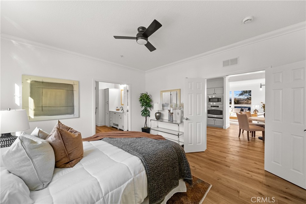 3909 Reche Road, Unit 60 Fallbrook, CA 92028 - Photo 13 of 37 a bedroom with a bed and wooden floor