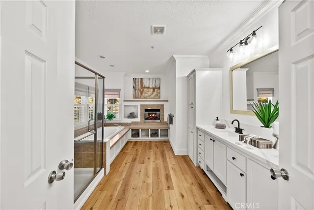 a large white kitchen with stainless steel appliances