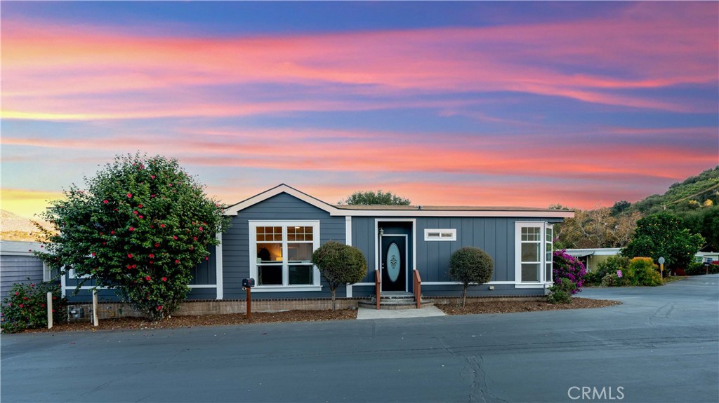 3909 Reche Road, Unit 60 Fallbrook, CA 92028 - Photo 2 of 37 a front view of a house with a garden