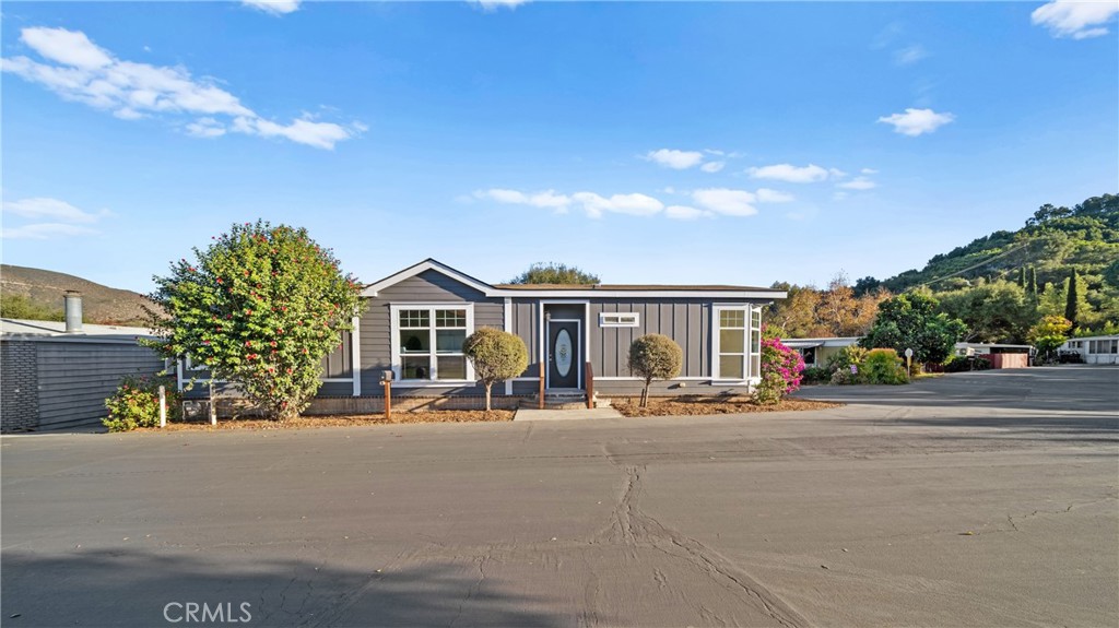 3909 Reche Road, Unit 60 Fallbrook, CA 92028 - Photo 27 of 37 a front view of a house with a yard